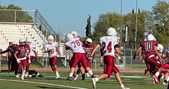 football players in red and white on playing field